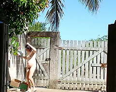 Nudist housewife on the street with the addition of in the front yard